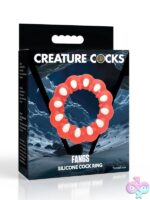 Red fang-textured silicone cock ring with inner bumps and outer white fangs by Xr - Creature Cocks