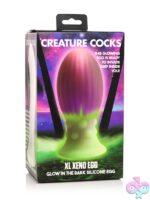 XL glow-in-the-dark pink silicone xeno egg with ribbed texture by Creature Cocks
