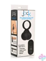 Large black vibrating silicone balls with remote control on a neutral background