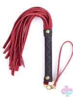 Mini leather flogger with 30 tails and wrapped handle in black, shown on neutral background