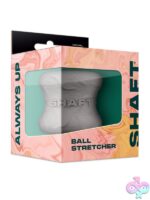 Shaft Model H liquid silicone ball stretcher in gray and green on neutral background