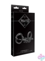 Pumped penis extender with spring-loaded steel traction rods shown in black and white variants