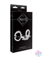 Pumped penis extender with spring-loaded steel traction rods shown in black and white variants