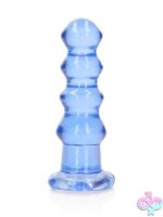 RealRock crystal clear curvy dildo and butt plug in blue, clear, and pink with suction cup base