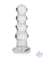 RealRock crystal clear curvy dildo and butt plug in blue, clear, and pink with suction cup base