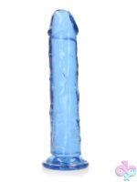 Realrock Crystal Clear straight realistic dildo with suction cup base standing upright on white background