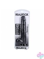 RealRock extra long realistic dildo with balls 13 inch shown upright displaying detailed veining and suction cup base