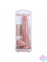 RealRock extra long realistic dildo with balls 13 inch shown upright displaying detailed veining and suction cup base