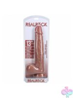 RealRock extra long realistic dildo with balls 13 inch shown upright displaying detailed veining and suction cup base