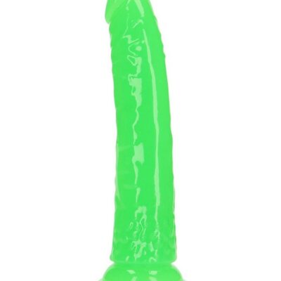 RealRock slim glow in the dark dildo standing upright showing neon glow effect on dark background