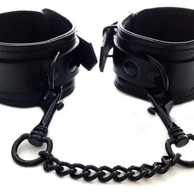 Black leather ankle cuffs with black metal hardware and detachable chain by Rouge Garments