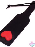 Black leather spanking paddle with red padded heart detail by Rouge Garments