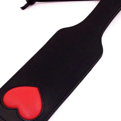 Black leather spanking paddle with red padded heart detail by Rouge Garments