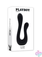 The Swan black dual-shaft rabbit vibrator standing upright on a nightstand, showing flexible silicone shafts and textured bulbous tips